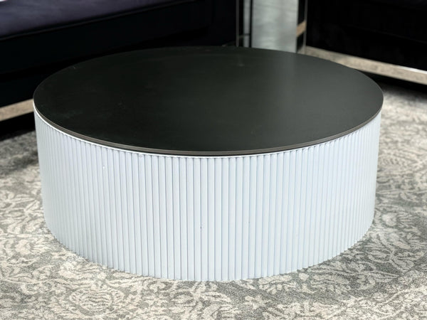 White Ripple coffee table with black top styled in living room décor