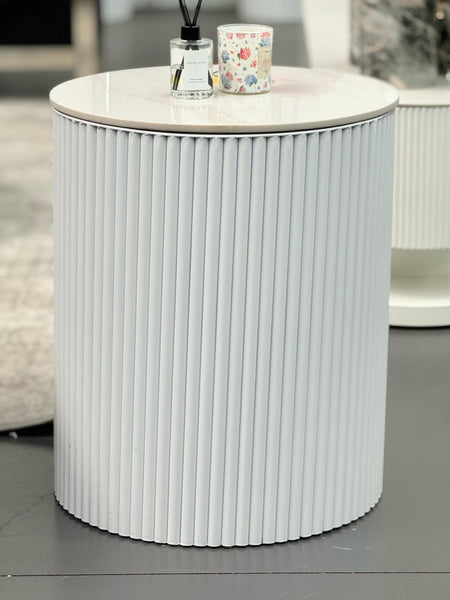 White Ripple round side table with ribbed body styled in living room