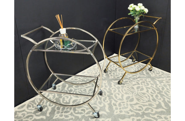 Roman trolleys styled with décor in modern black and gold tones.