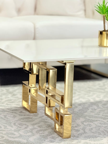 Close-up view of Royale gold coffee table with luxurious marble stone top and bold frame.