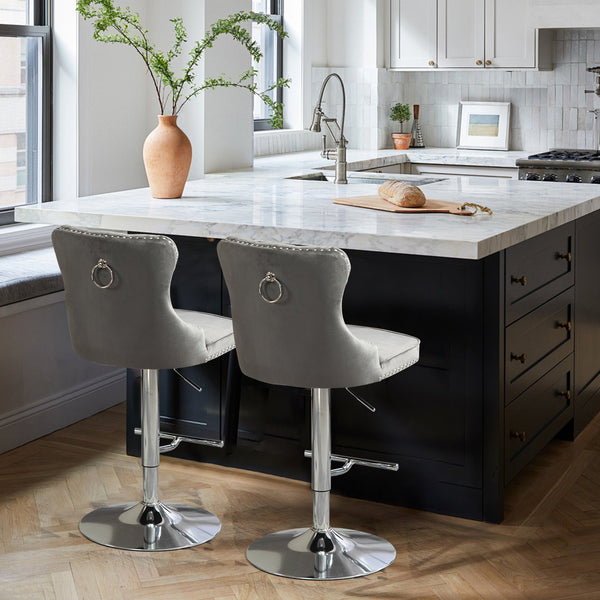 Pair of grey velvet Sahara swivel bar stools with silver stand styled in modern kitchen space