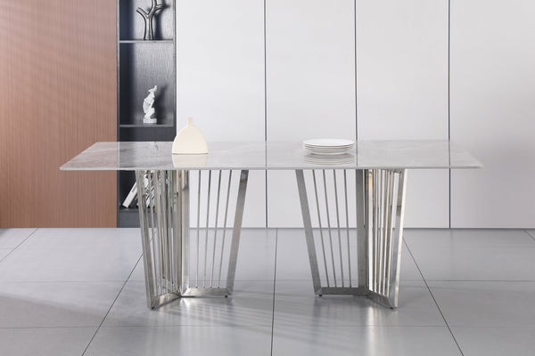 Serena Dining Table silver stainless frame styled with white marble top in elegant setting.