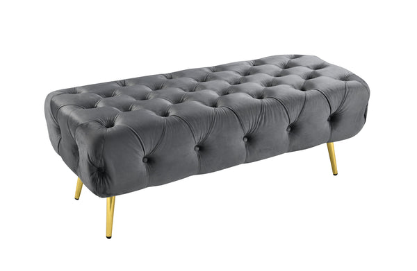 Dark Grey Shirley Ottoman featuring a sturdy gold frame and tufted velvet cushioned top.
