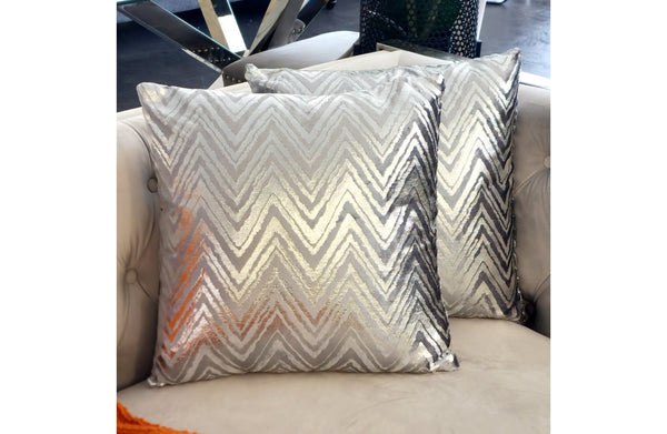 Silver cushion with bold zig-zag pattern on textured fabric, perfect for modern sofas and accent chairs

