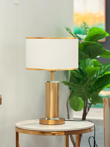 Tiffany Table Lamp with gold base and white lampshade styled on side table with décor accents