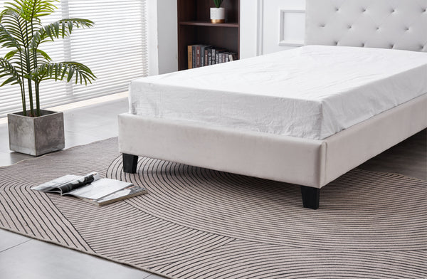 Close-up of Winston Velvet Bed frame in light grey with sturdy black wooden legs.