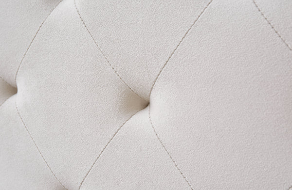 Close-up of Winston Bed tufted headboard detail in soft light grey velvet upholstery